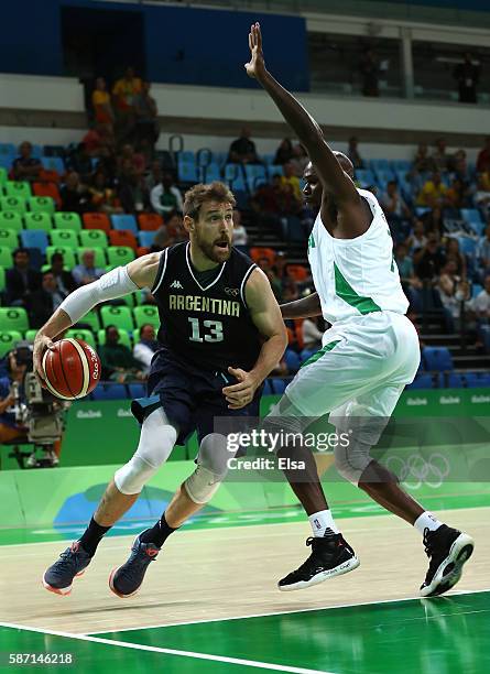 Andres Nocioni of Argentina drives the ball against Al-Farouq Aminu of Nigeria during a Men's preliminary round basketball game between Nigeria and...