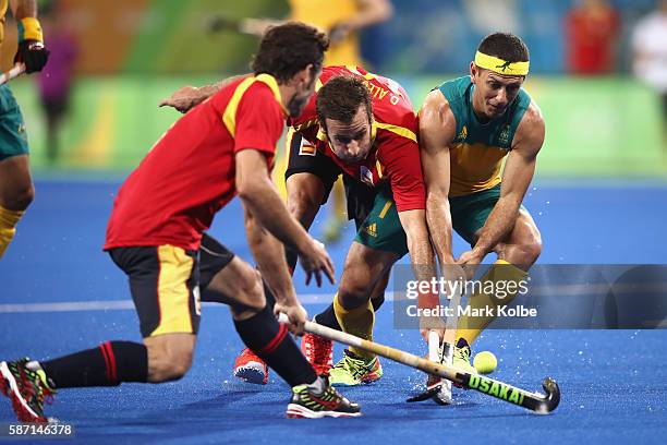 David Alegre of Spain and Jamie Dwyer of Australia compete for the ball during the men's pool A match between Brazil and Belgium on Day 2 of the Rio...