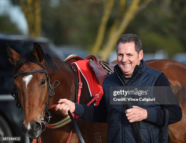 Trainer Grahame Begg is seen with Mossin 'Around before trialing in Heat 2 during the Cranbourne barrier trials on August 8, 2016 in Cranbourne,...