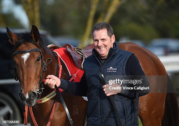 Trainer Grahame Begg is seen with Mossin 'Around before trialing in Heat 2 during the Cranbourne barrier trials on August 8, 2016 in Cranbourne,...