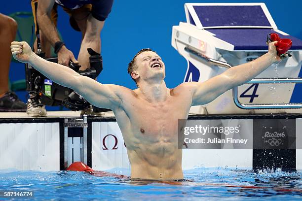 Adam Peaty of Great Britain celebrates winning gold and setting a new world record in the Men's 100m Breaststroke Final on Day 2 of the Rio 2016...