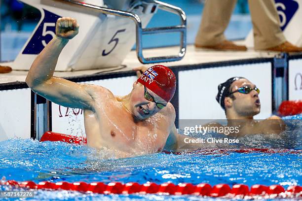 Adam Peaty of Great Britain celebrates winning gold and setting a new world record in the Men's 100m Breaststroke Final on Day 2 of the Rio 2016...