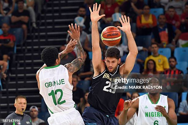 Argentina's shooting guard Patricio Garino defends against Nigeria's forward Michael Gbinije during a Men's round Group B basketball match between...