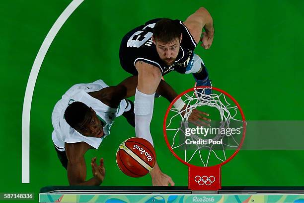 Andy Ogide of Nigeria shoots against Andres Nocioni of Argentina during a Men's preliminary round basketball game between Nigeria and Argentina on...