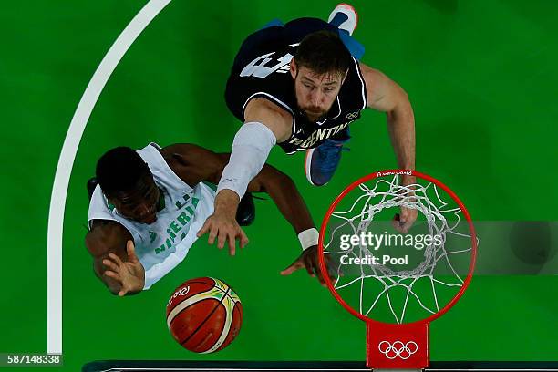 Andy Ogide of Nigeria shoots against Andres Nocioni of Argentina during a Men's preliminary round basketball game between Nigeria and Argentina on...