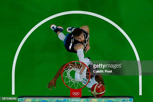 Andy Ogide of Nigeria shoots against Andres Nocioni of Argentina during a Men's preliminary round basketball game between Nigeria and Argentina on...