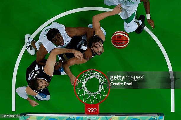 Marcos Delia of Argentina, Andres Nocioni of Argentina and Ike Diogu of Nigeria watch the ball during a Men's preliminary round basketball game...
