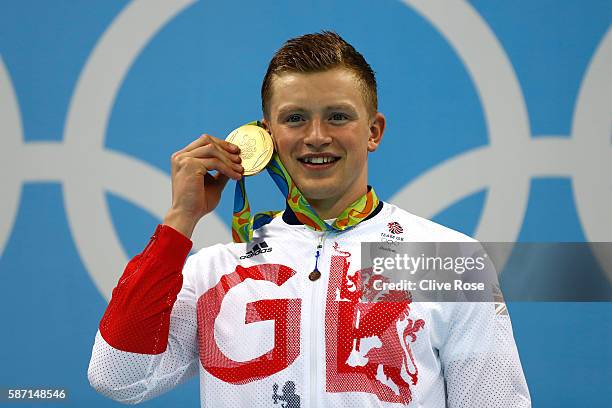 Gold medalist Adam Peaty of Great Britain poses on the podium during the medal ceremony for the Men's 100m Breaststroke Final on Day 2 of the Rio...
