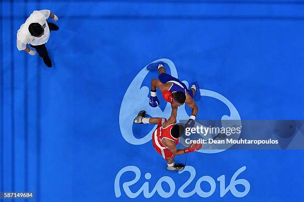 Sofiane Oumiha of France lands a punch on Teofimo Andres Lopez Rivera of Honduras as they compete in the Men's Light 60kg preliminary bout on Day 2...