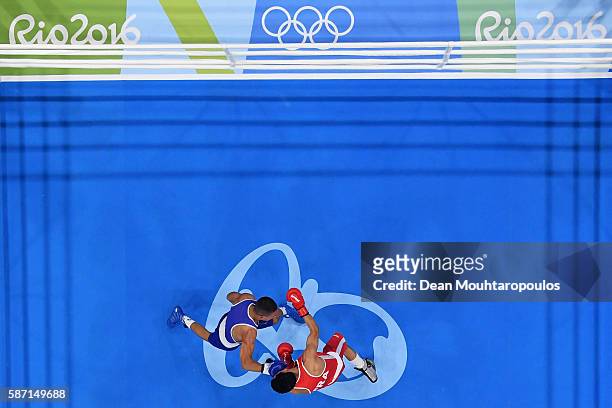 Sofiane Oumiha of France lands a punch on Teofimo Andres Lopez Rivera of Honduras as they compete in the Men's Light 60kg preliminary bout on Day 2...