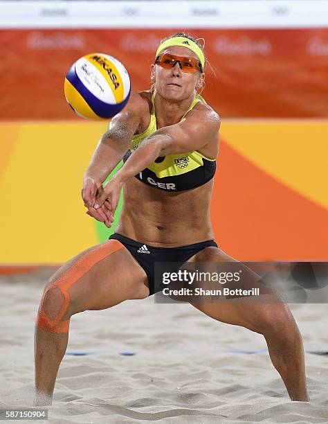 Karla Borger of Germany in action during the Women's Beach Volleyball preliminary round Pool E match against Nadine Zumkehr and Joana Heidrich of...