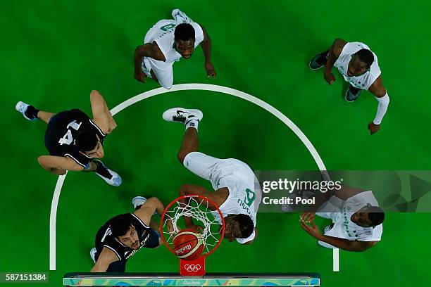 Ike Diogu of Nigeria shoots against Gabriel Deck and Roberto Acuna of Argentina during a Men's preliminary round basketball game between Nigeria and...