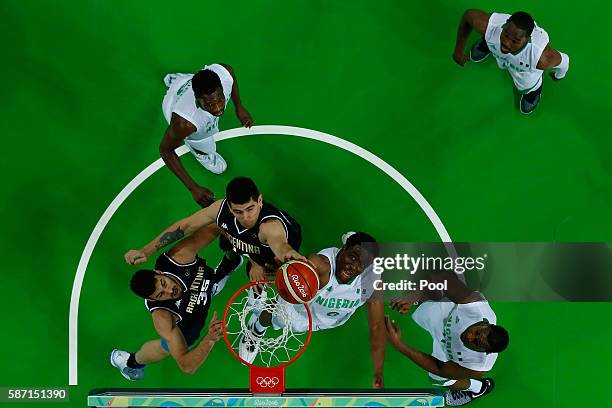 Ike Diogu of Nigeria shoots against Gabriel Deck and Roberto Acuna of Argentina during a Men's preliminary round basketball game between Nigeria and...