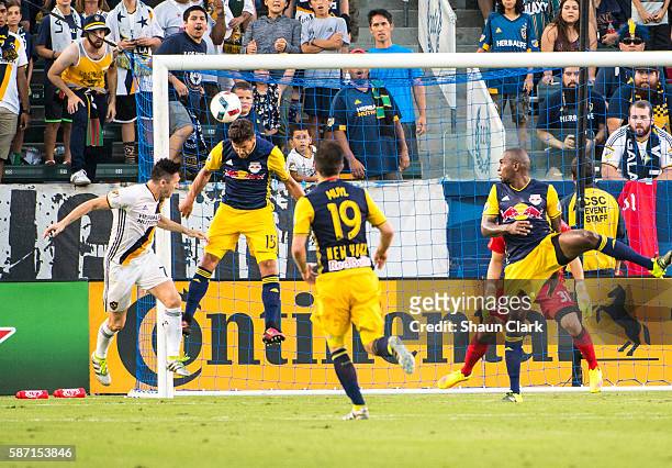 Robbie Keane of Los Angeles Galaxy tries to get a header on goal as Salvatore Zizzo of New York Red Bulls defends during Los Angeles Galaxy's MLS...