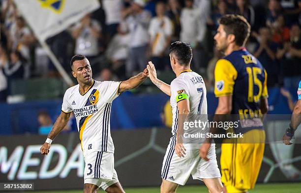 Robbie Keane of Los Angeles Galaxy congratulates Ashley Cole of Los Angeles Galaxy following his goal during Los Angeles Galaxy's MLS match against...