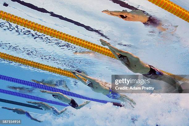 Conor Dwyer of the United States, Paul Biedermann of Germany and James Guy of Great Britain compete in the first Semifinal of the Men's 200m...