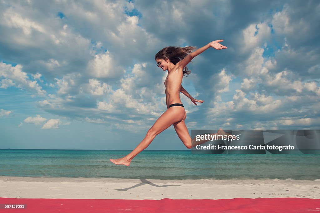 Woman jumping on the beach