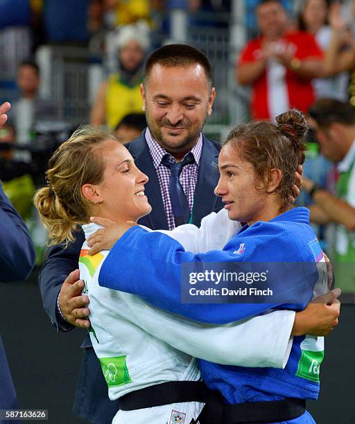 Under 52kg silver medallist, Odette Giuffrida of Italy, white, congratulates Majlinda Kelmendi of Kosovo on her victory watched by Kelmendi's coach,...