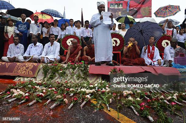 Muslim cleric delivers a prayer while other religious leaders listen at an inter-faith service during a rally in central Mahabandoola Park in Yangon...