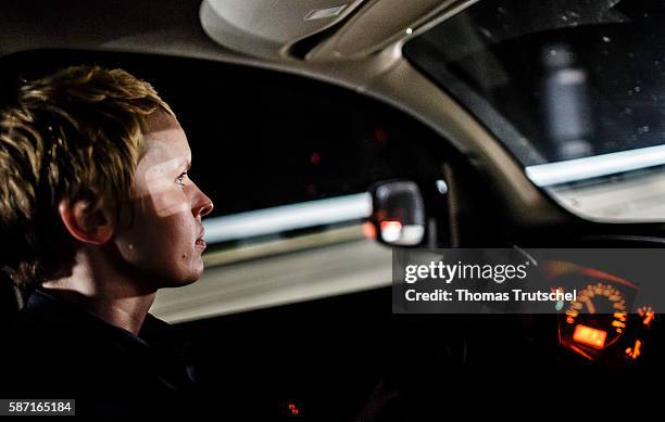 Dresden, Germany A woman driving in her car on the highway at night on August 06, 2016 in Dresden, Germany.