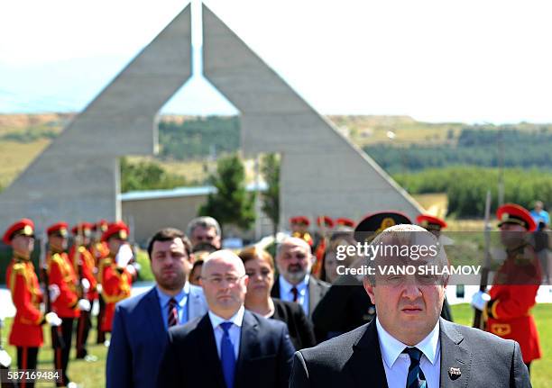 Georgian President Giorgi Margvelashvili attends a wreath laying ceremony at a cemetery in Tbilisi on August 8, 2016 as Georgians mark the eighth...