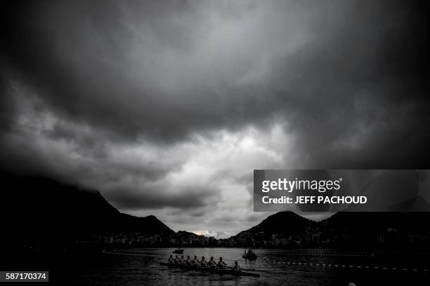 Rowers warm up at the Lagoa Rodrigo de Freitas ahead of their race at the Rio 2016 Olympic Games in Rio de Janeiro on August 8, 2016. Jeff PACHOUD /...