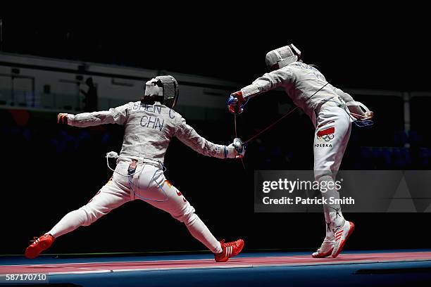 Chen Shen of China and Malgorzata Kozaczuk of Poland compete during the Women's Individual Sabre on Day 3 of the Rio 2016 Olympic Games at Carioca...