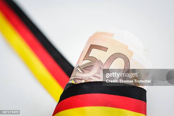 Berlin, Germany 50 Euro bills with a ribbon in the national colors of Germany on August 08, 2016 in Berlin, Germany.