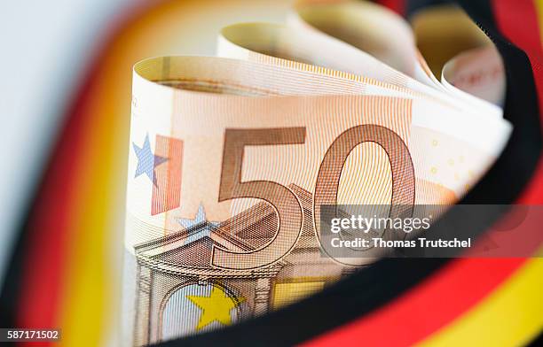 Berlin, Germany 50 Euro bills with a ribbon in the national colors of Germany on August 08, 2016 in Berlin, Germany.