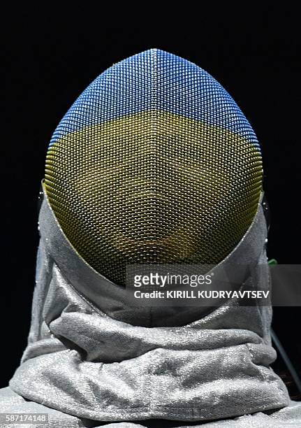 Ukraine's Olena Kravatska reacts as she competes against US Ibtihaj Muhammad during their womens individual sabre qualifying bout as part of the...