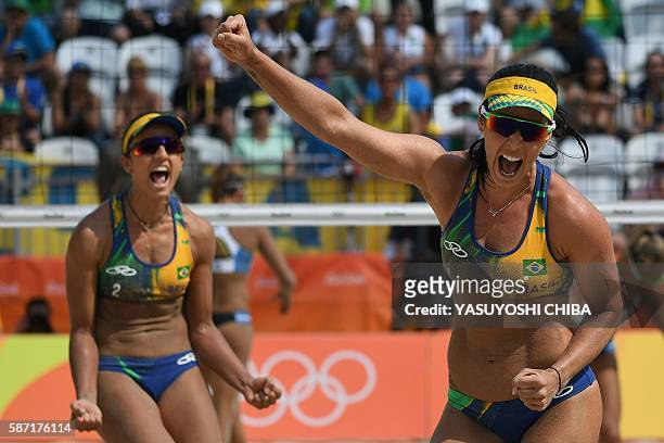 Brazil's Barbara Seixas De Freitas and Brazil's Agatha Bednarczuk react after wining the women's beach volleyball qualifying match between Brazil and...