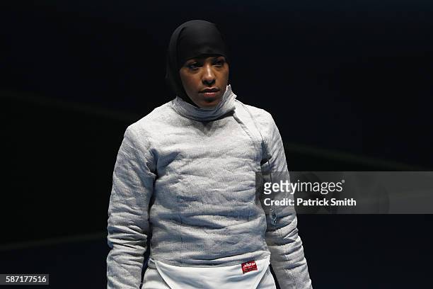 Ibtihaj Muhammad of the United States look dejected after defeat to Cecilia Berder of France during the Women's Individual Sabre on Day 3 of the Rio...