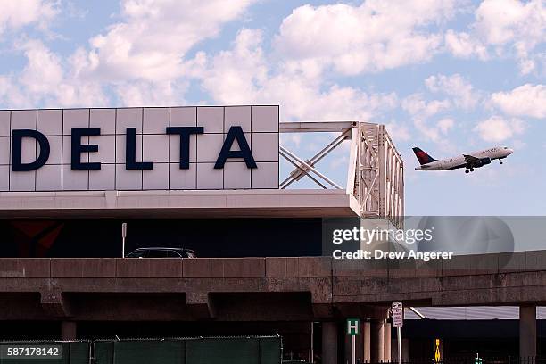 Delta jet takes off at LaGuardia Airport , August 8, 2016 in the Queens borough of New York City. Delta flights around the globe were grounded and...