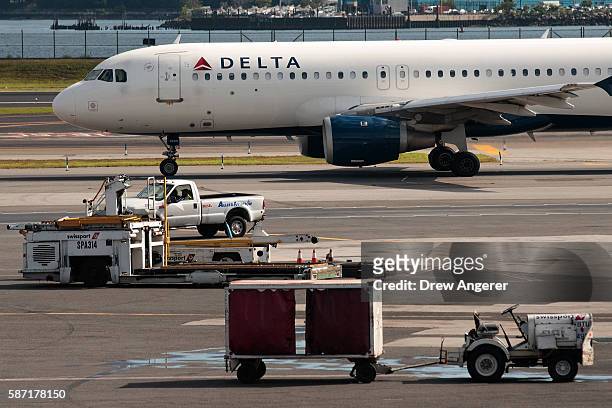 Delta jet taxis on the tarmac at LaGuardia Airport , August 8, 2016 in the Queens borough of New York City. Delta flights around the globe were...