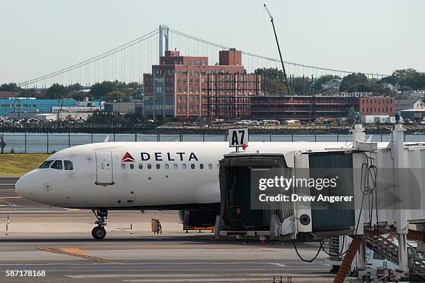 Delta jet taxis on the tarmac at LaGuardia Airport , August 8, 2016 in the Queens borough of New York City. Delta flights around the globe were...