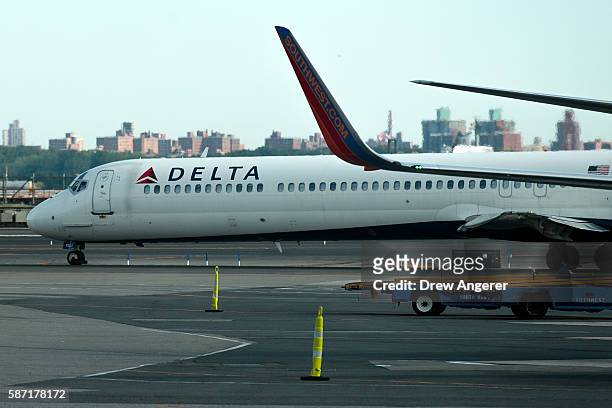 Delta jet taxis on the tarmac at LaGuardia Airport , August 8, 2016 in the Queens borough of New York City. Delta flights around the globe were...