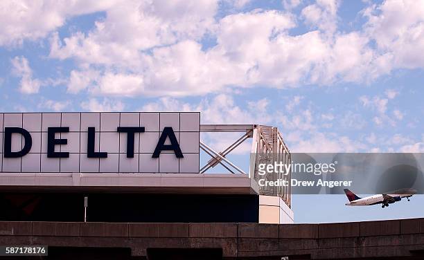 Delta jet takes off at LaGuardia Airport , August 8, 2016 in the Queens borough of New York City. Delta flights around the globe were grounded and...