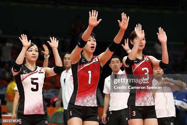 Arisa Sato, Miyu Nagaoka and Saori Kimura of Japan thank the crowd after winning the Women's Preliminary Pool A match between Japan and Cameroon on...