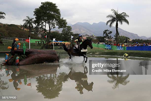 Frida Andersen of Sweden riding Herta Bayro clears a water jump during the Cross Country Eventing on Day 3 of the Rio 2016 Olympic Games at the...