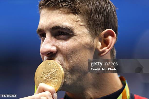 Michael Phelps from the United States of America kisses his medal during the awarding ceremony of the swimming final of men's 4x100m freestyle relay...
