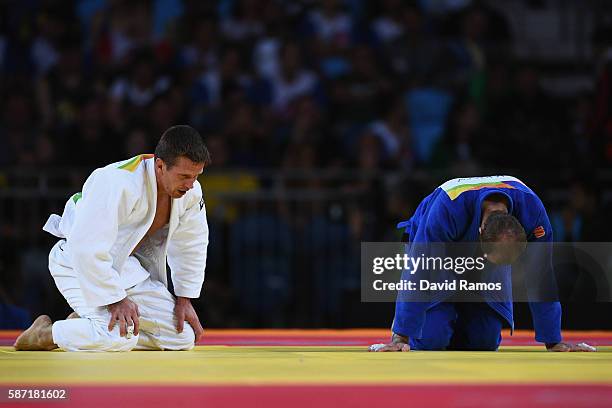 Dirk van Tichelt of Belgium and Denis Iartcev of Russia react after van Tichelt wins in the Men's -73 kg Judo quarterfinal on Day 3 of the Rio 2016...