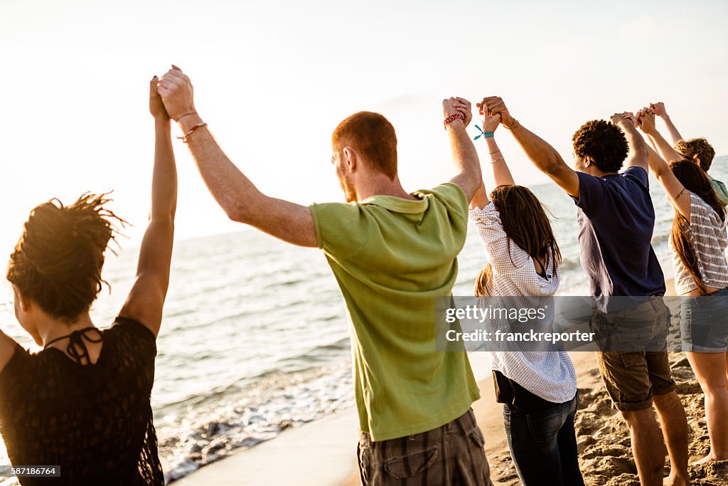 Volunteer with arm raised at sunset