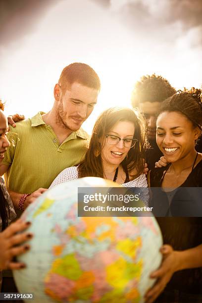 teenagers college student smiling with globe - international humanitarian aid stock pictures, royalty-free photos & images