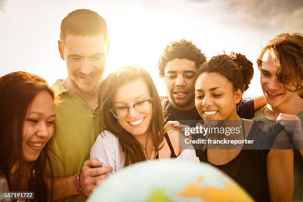 teenagers college student smiling with globe - international humanitarian aid stock pictures, royalty-free photos & images