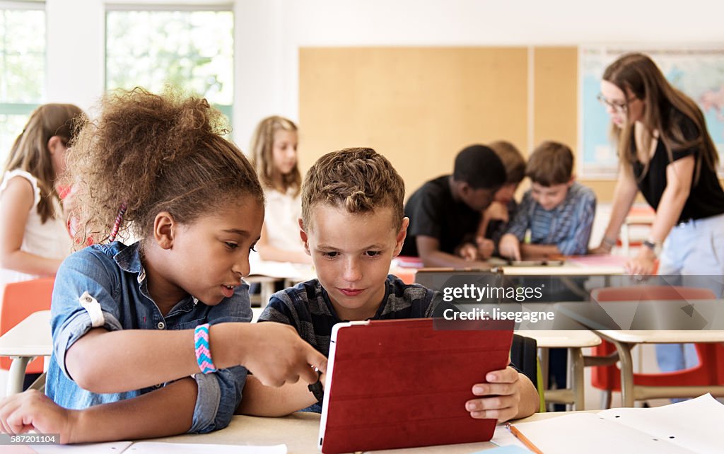 デジタルタブレットを使用してクラスの学校の子供たち