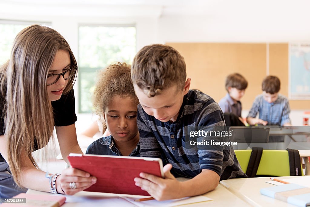School kids in class using a digital tablet