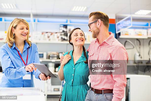 young couple in an appliance store - buying appliances stock pictures, royalty-free photos & images