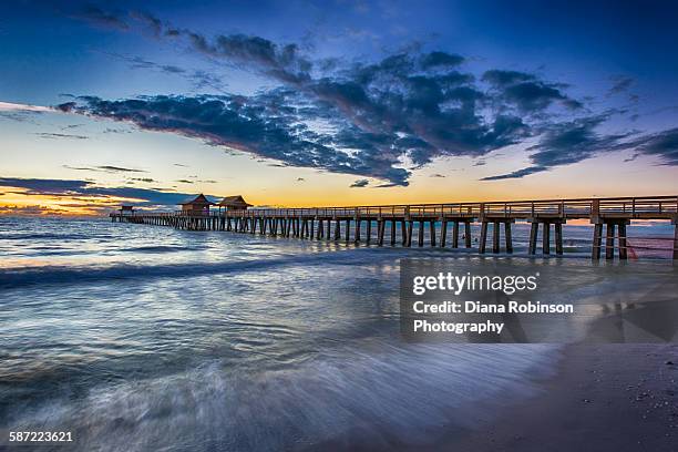 sunset over the naples pier, naples, florida - naples florida stock-fotos und bilder