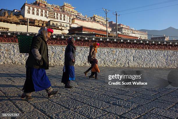 Village woman walk past Songzanlin Monastery, on the outskirts of Shangri-La , Yunnan Province, China, 2012.