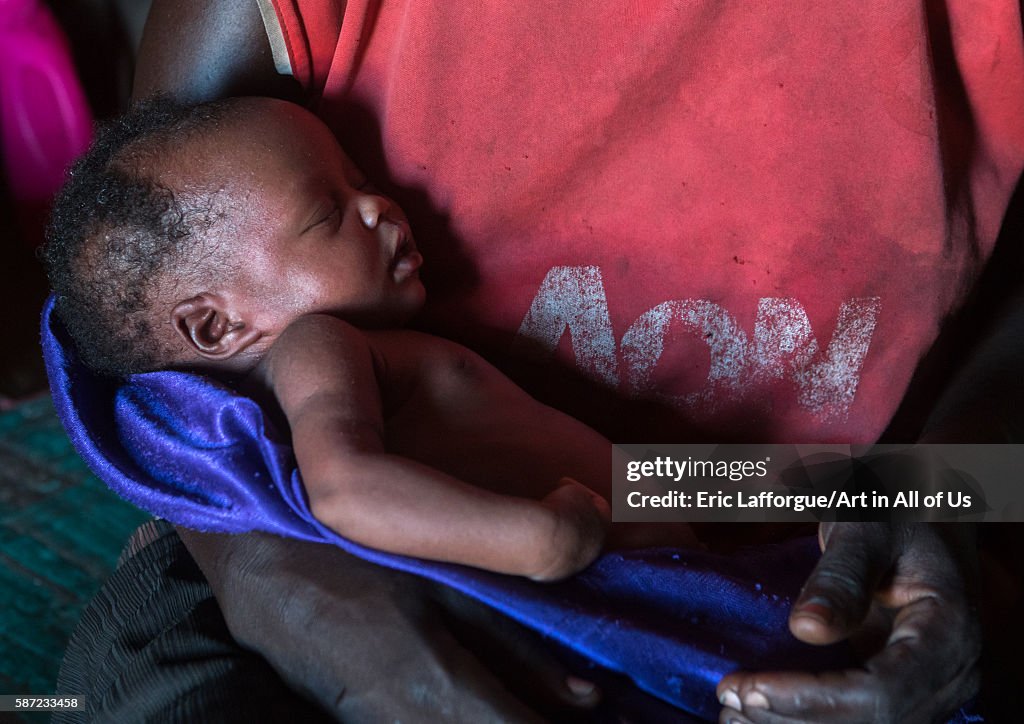 Toposa mother with her new born baby in her hut, Omo valley, Kangate, Ethiopia